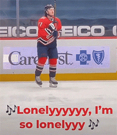 A Hockey Player Is Standing On The Ice In Front Of A Sign For Eico GIF