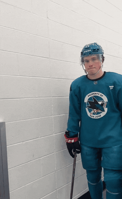 A Hockey Player Is Wearing A Blue Jersey That Says Property Of San Jose GIF