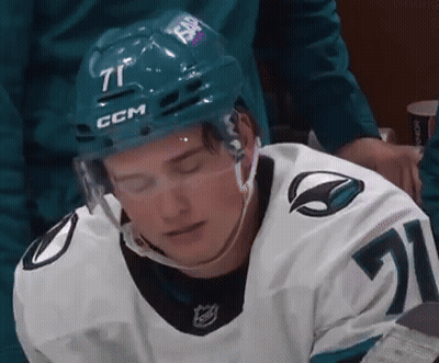 A Hockey Player Is Wearing A Helmet With The Number 71 On It GIF