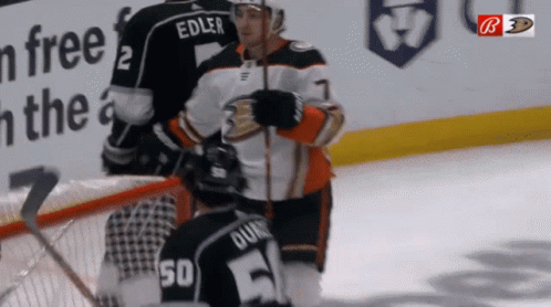 A Hockey Player Named Edler Is Kneeling Down On The Ice GIF