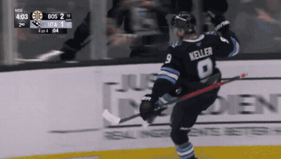 A Hockey Player Named Keller Is Holding A Hockey Stick GIF