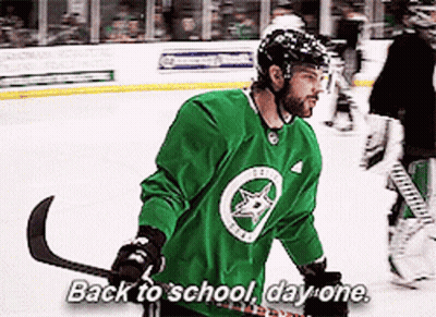 A Hockey Player Says Back To School Day One While Holding A Hockey Stick GIF