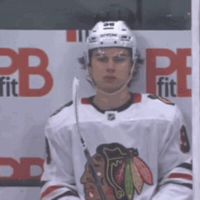 A Hockey Player Stands In Front Of A Cb Fit Sign GIF