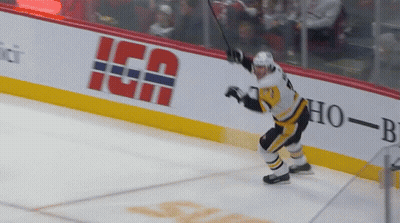 A Hockey Player Stands On The Ice In Front Of A Banner That Says " Ica " GIF