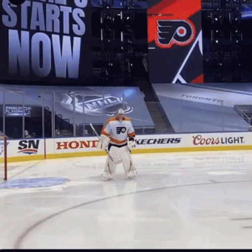 A Hockey Player Stands On The Ice In Front Of A Sign That Says Starts Now GIF