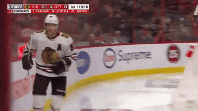 A Hockey Player Stands On The Ice In Front Of A Supreme Banner GIF