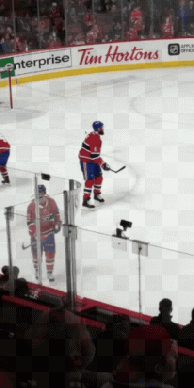 A Hockey Player Stands On The Ice In Front Of A Tim Hortons Advertisement GIF