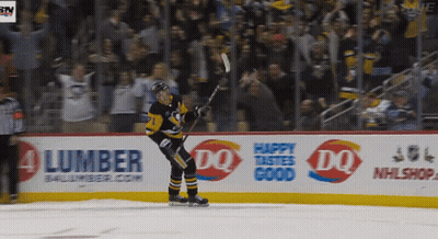 A Hockey Player Stands On The Ice In Front Of An Ad For Lumber And Dq GIF