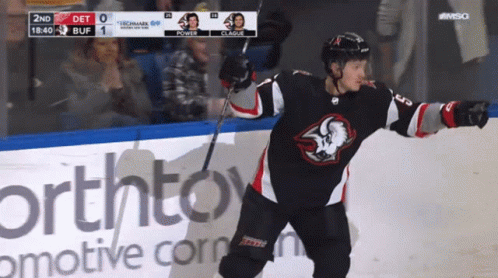 A Hockey Player Stands On The Ice In Front Of An Advertisement For Northtown GIF