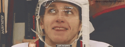 A Hockey Player Wearing A Bauer Helmet Is Smiling GIF