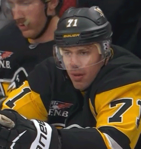 A Hockey Player Wearing A Black And Yellow Jersey With The Number 71 On His Helmet GIF