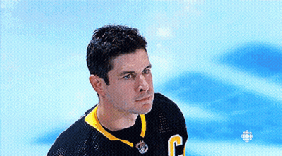 A Hockey Player Wearing A Black Jersey With The Letter C On It GIF