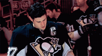 A Hockey Player Wearing A Black Jersey With The Letter C On It GIF
