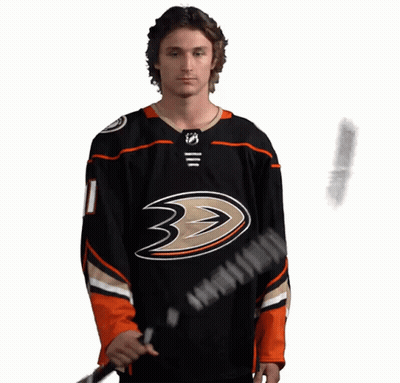 A Hockey Player Wearing A Black Jersey With The Number 11 On It GIF