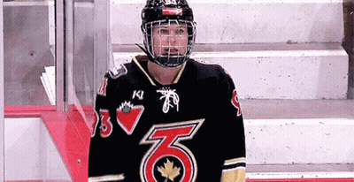 A Hockey Player Wearing A Black Jersey With The Number 6 On The Front GIF