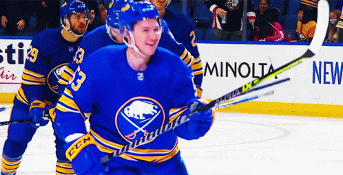 A Hockey Player Wearing A Blue Jersey With The Number 53 On It GIF