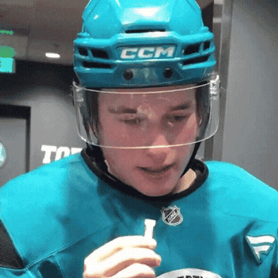 A Hockey Player Wearing A Ccm Helmet Holds A Stick GIF