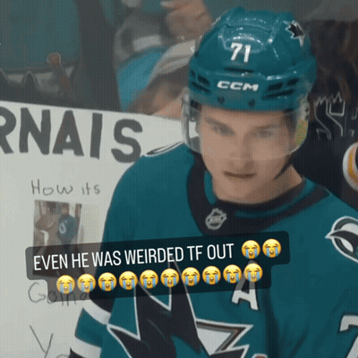 A Hockey Player Wearing A Ccm Helmet Stands In Front Of A Sign That Says Rnais GIF
