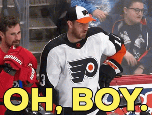 A Hockey Player Wearing A Flyers Jersey Stands In Front Of A Sign That Says Oh Boy GIF