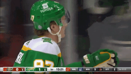 A Hockey Player Wearing A Green Helmet That Says Toyota GIF