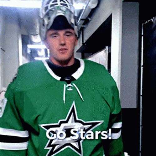 A Hockey Player Wearing A Green Jersey With A Star On It Says Go Stars GIF