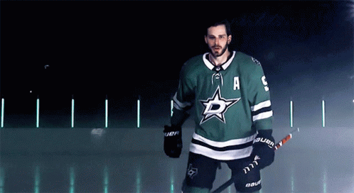 A Hockey Player Wearing A Green Jersey With The Letter A On The Front GIF