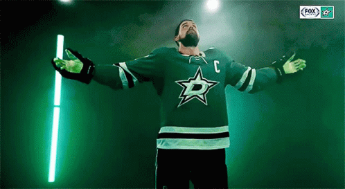 A Hockey Player Wearing A Green Jersey With The Letter C On The Front GIF