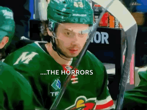 A Hockey Player Wearing A Green Jersey With The Letter M On The Front GIF