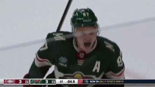 A Hockey Player Wearing A Green Jersey With The Number 8 On It GIF