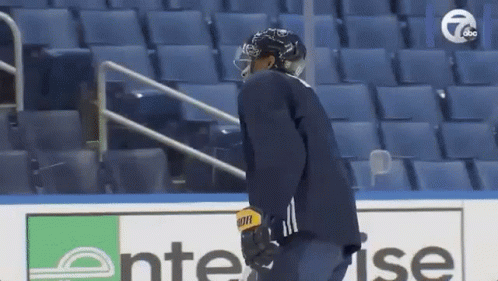 A Hockey Player Wearing A Helmet And A Bauer Jersey GIF