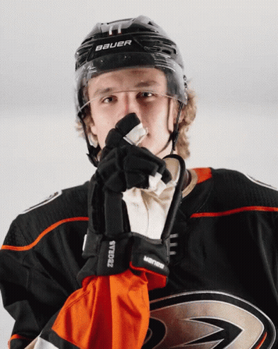 A Hockey Player Wearing A Helmet And Gloves With The Word Bauer On It GIF