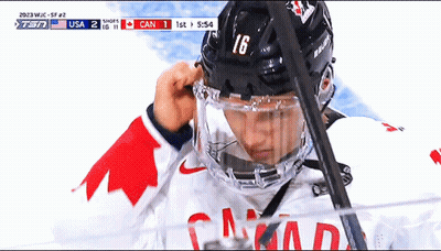 A Hockey Player Wearing A Helmet With The Number 16 GIF