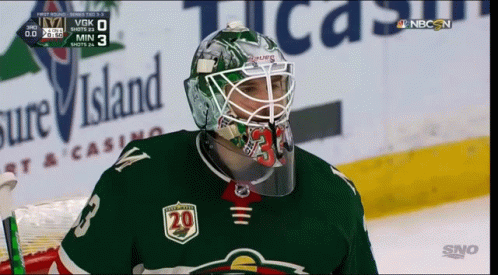 A Hockey Player Wearing A Helmet With The Number 20 On The Front GIF