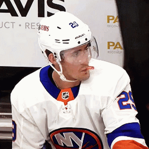 A Hockey Player Wearing A Helmet With The Number 23 GIF