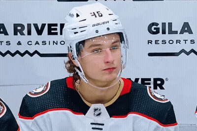 A Hockey Player Wearing A Helmet With The Number 46 On It . GIF