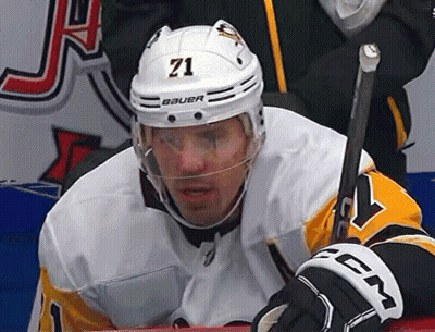 A Hockey Player Wearing A Helmet With The Number 71 GIF