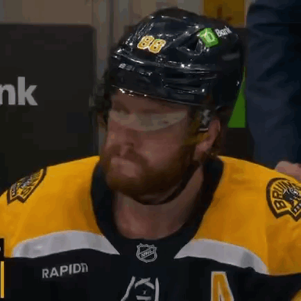 A Hockey Player Wearing A Helmet With The Number 86 On It . GIF