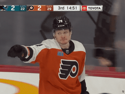 A Hockey Player Wearing A Jersey That Says Flyers Is Pointing At Something GIF
