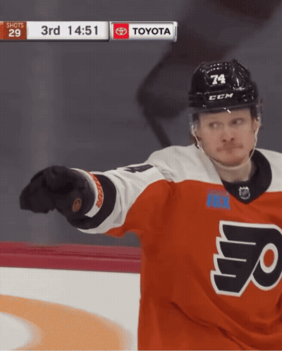A Hockey Player Wearing A Jersey That Says Flyers Is Pointing At The Camera GIF