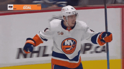 A Hockey Player Wearing A Jersey That Says Ny Is Holding A Stick GIF