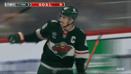 A Hockey Player Wearing A Jersey With The Letter C On It Celebrates A Goal GIF