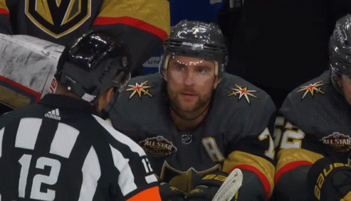 A Hockey Player Wearing A Jersey With The Number 12 On It GIF