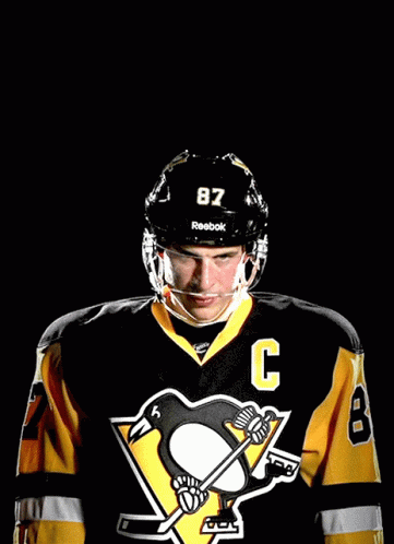 A Hockey Player Wearing A Jersey With The Number 87 On It GIF