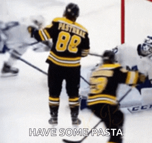 A Hockey Player Wearing A Jersey With The Number 88 Is Standing On The Ice Next To Another Hockey Player . GIF