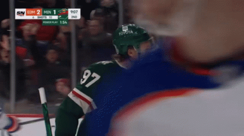 A Hockey Player Wearing A Jersey With The Number 97 GIF