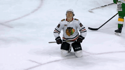 A Hockey Player Wearing A Jersey With The Number 98 On It GIF