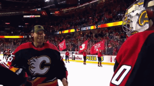 A Hockey Player Wearing A Number 0 Jersey Stands On The Ice GIF