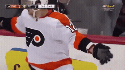 A Hockey Player Wearing A Number 11 Jersey Is Standing On The Ice GIF