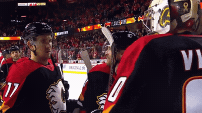 A Hockey Player Wearing A Number 17 Jersey Talks To Another Player GIF