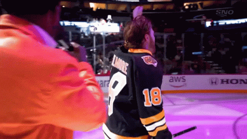 A Hockey Player Wearing A Number 18 Jersey GIF